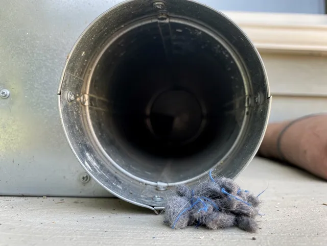 Shaker Heights Dryer Vent Cleaning technician using specialized equipment to clear severe dryer vent blockage in Shaker Heights